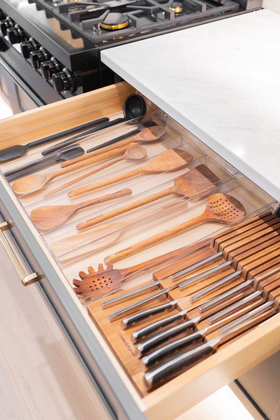 An organized utensil and knife drawer in a client kitchen