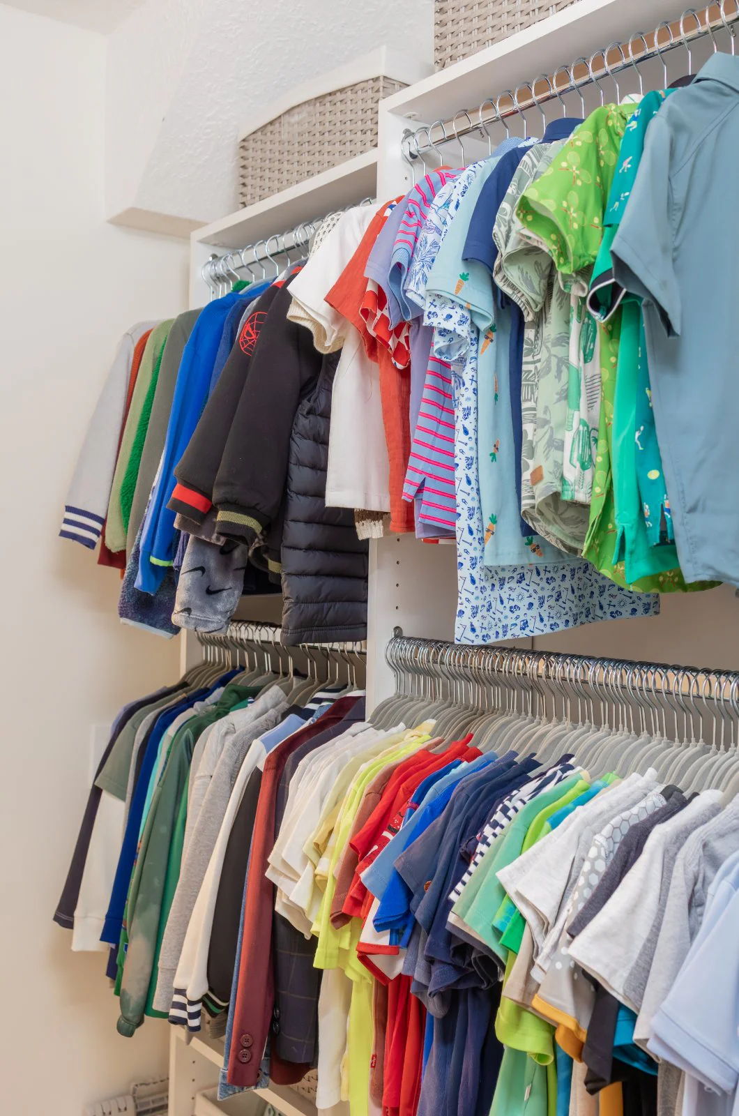 A child's closet, sorted by type and color